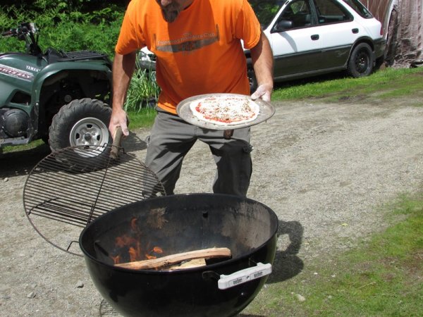 Pizza Fishingpol putting pizza in grill.jpg