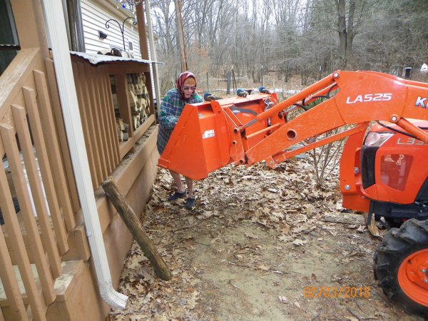 Putting wood on porch-1.JPG