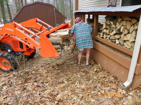 PUtting wood on porch-2.JPG